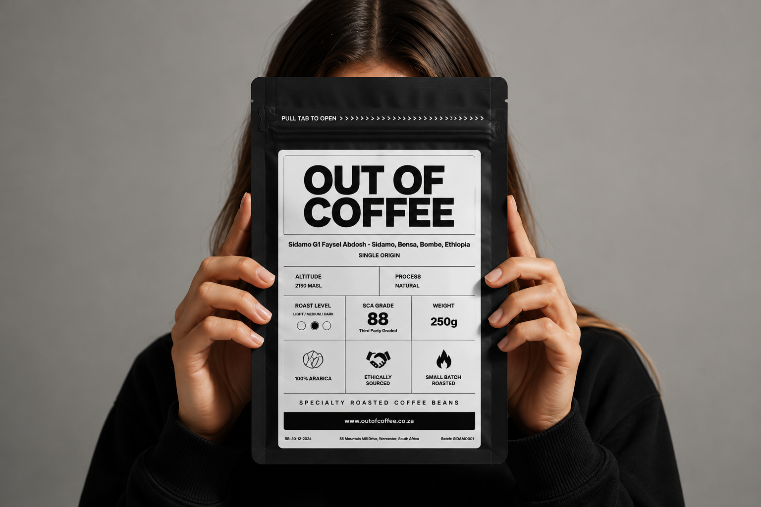 Out of Coffee black coffee bag held in front of a person